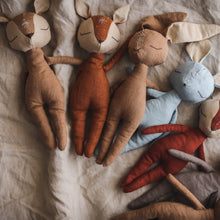 Charger l'image dans la galerie, Handmade linen animal dolls: fawn, fox, hare, mouse... displayed in an arch on a subtle earthy linen backdrop. Each has hand-embroidered details on the forehead, with different whimsical symbols.